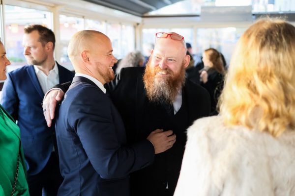 Candid scene of business professionals enjoying a jovial moment together indoors.