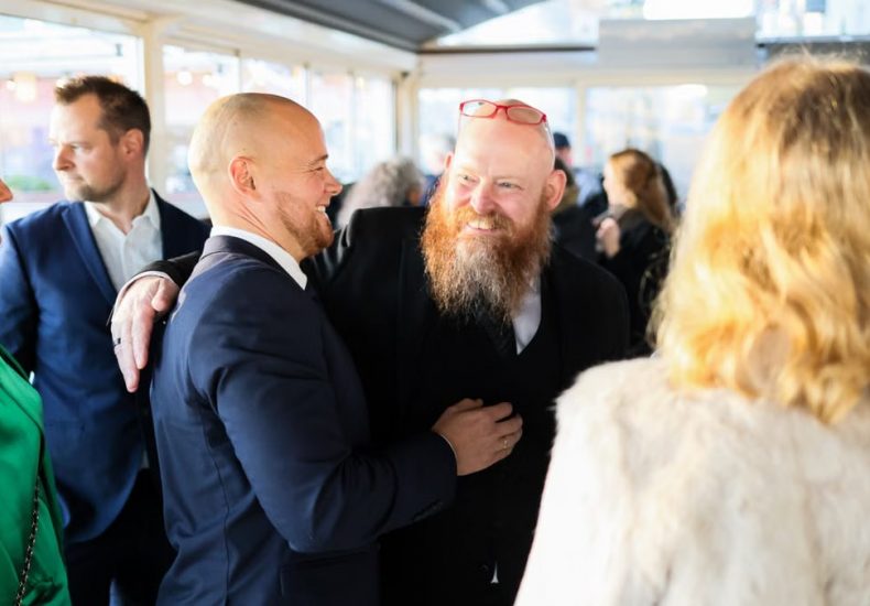 Candid scene of business professionals enjoying a jovial moment together indoors.
